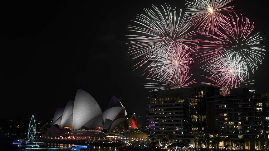 Fireworks explode over Sydney's Opera House and Harbour Bridge at night