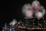 Fireworks explode over Sydney's Opera House and Harbour Bridge at night