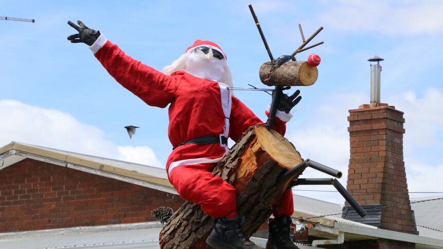 A stuffed Santa rides a wooden Rudolph in the northern Tasmanian town of Lilydale.