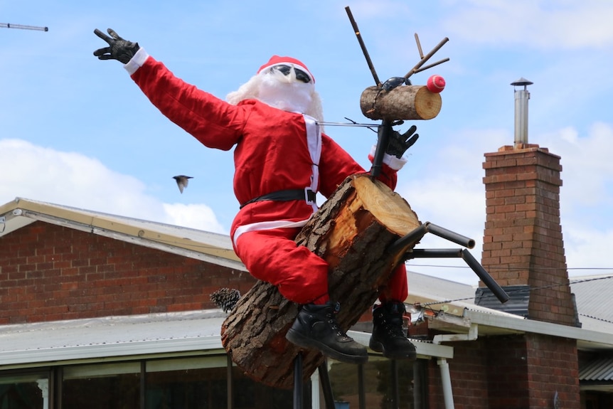 A stuffed Santa rides a wooden Rudolph in the northern Tasmanian town of Lilydale.