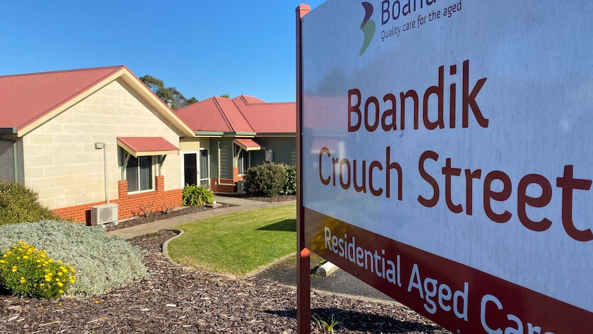 A sign saying 'Boandik Crouch Street' in front of residential units.