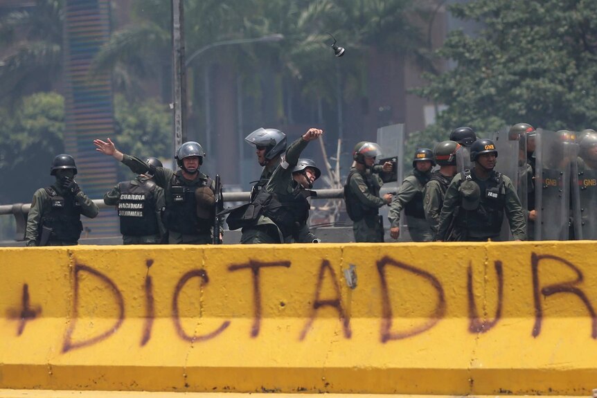 Police in Venezuela throw grenades during a protest in Caracas