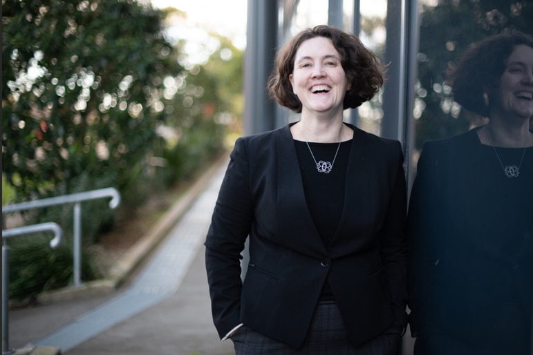 A woman smiling in a suit