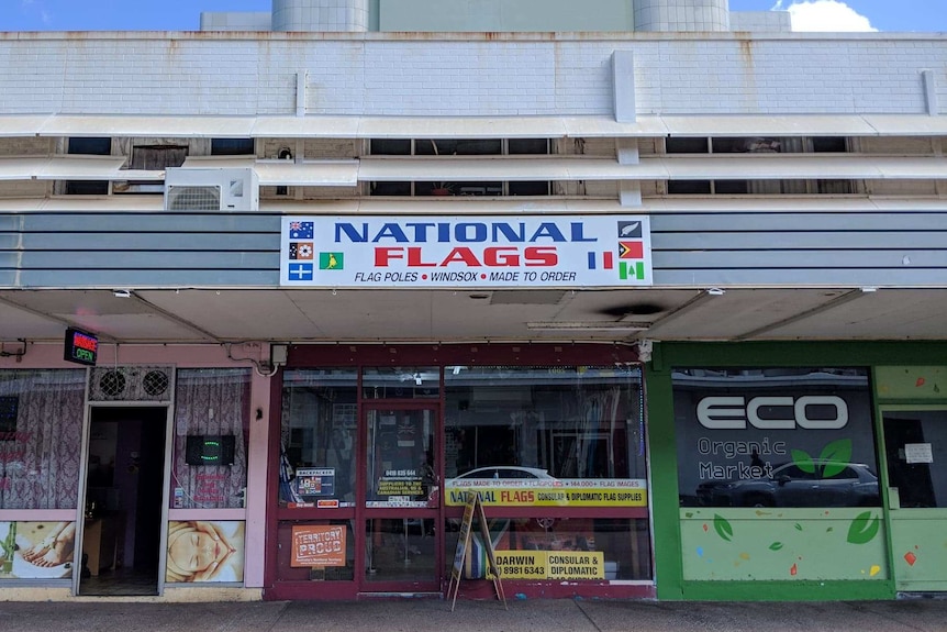 Flag shop sign on street.