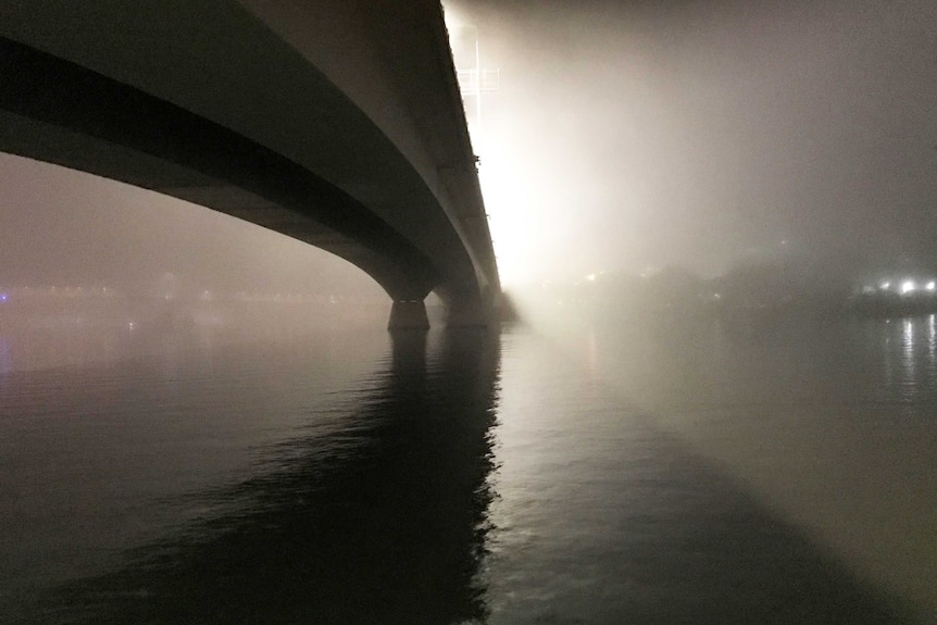 Fog hides Brisbane's Captain Cook Bridge and city buildings on July 7, 2017.