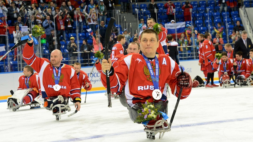 Russia's Sledge Hockey team players show their silver medals.