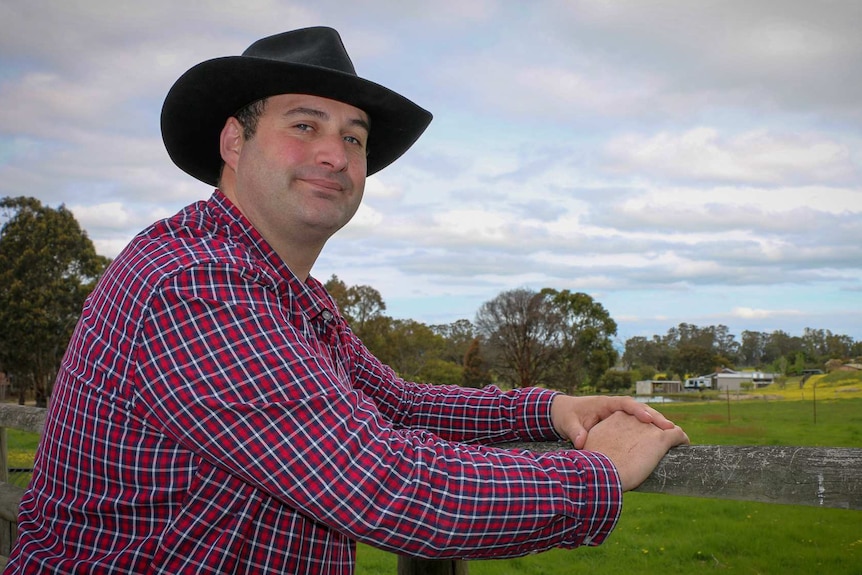 Ron D'Arcy leans on the fence of his property in Toongabbie.