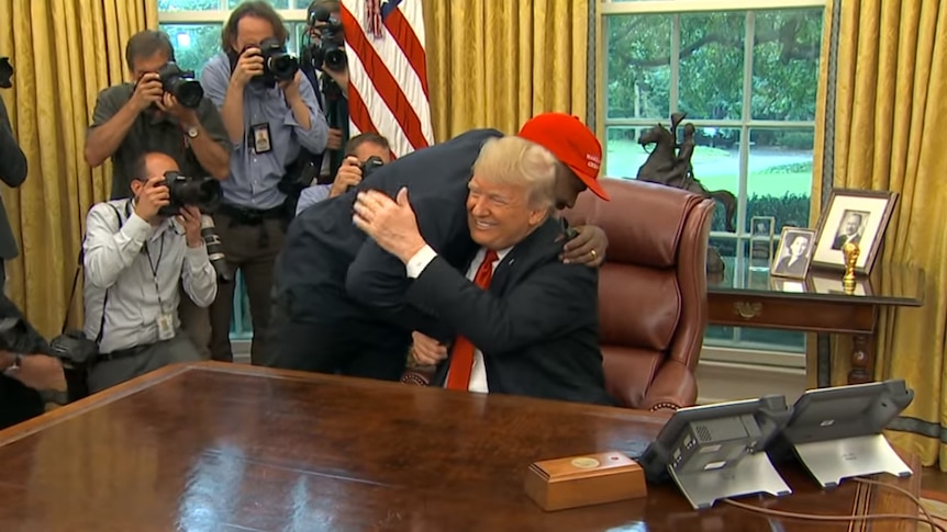 Kanye West embraces Donald Trump in the White House Oval Office