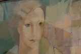 A photo of a pastel painting of a woman's face. 