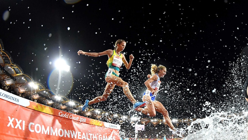 Victoria Mitchell jumps over an obstacle during the steeplechase final.