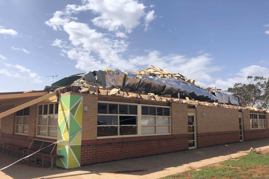 A school building with significant damage to the roof.