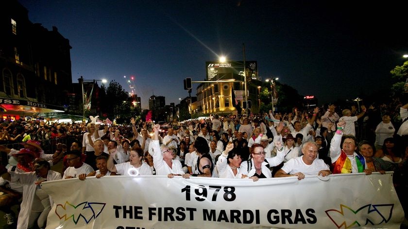 The first Mardi Gras entrants from 1978 march behind a banner on Oxford Street in 2008.