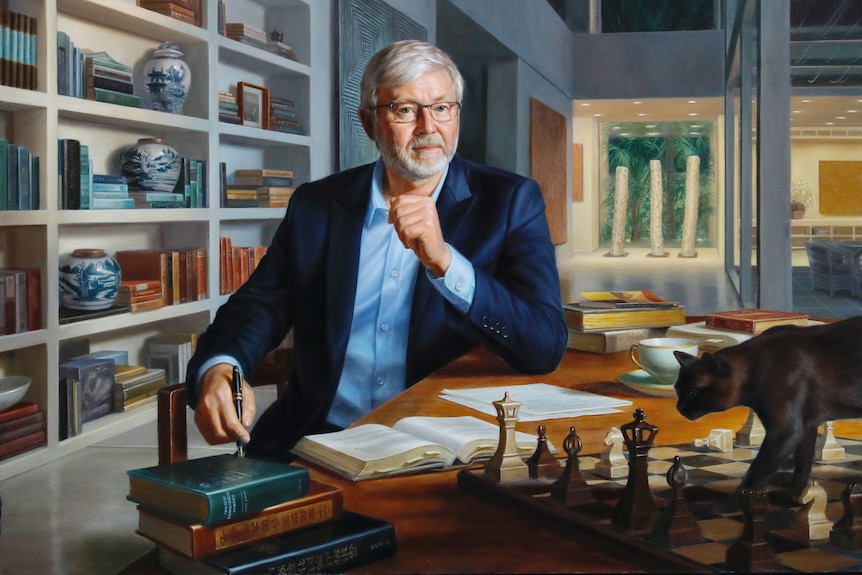 An oil painting of Kevin Rudd in his Queensland home, a cat wanders on the table in front of him, a wall of books behind him.