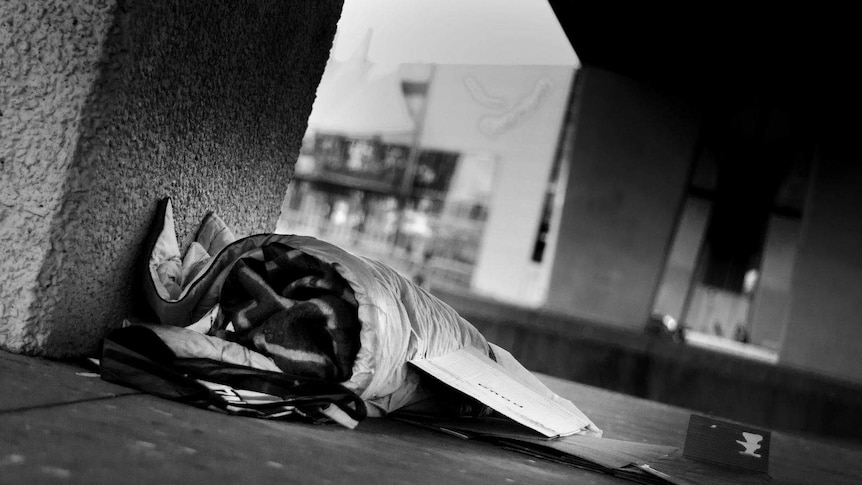 A sleeping bag and a cardboard box for a bed on the streets in Melbourne.