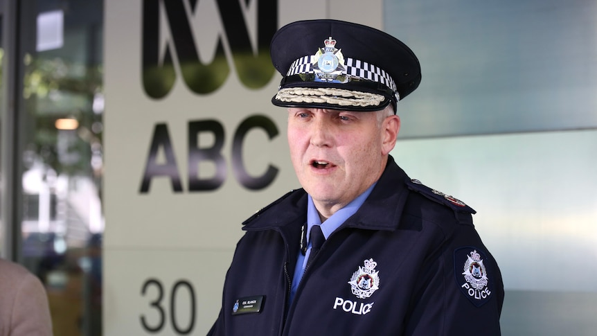 The Police Commissioner outside an ABC News sign