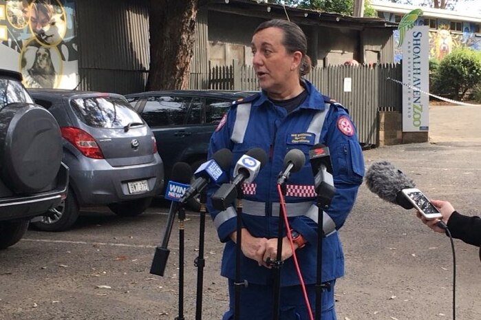 A female ambulance officer speaks to the media.