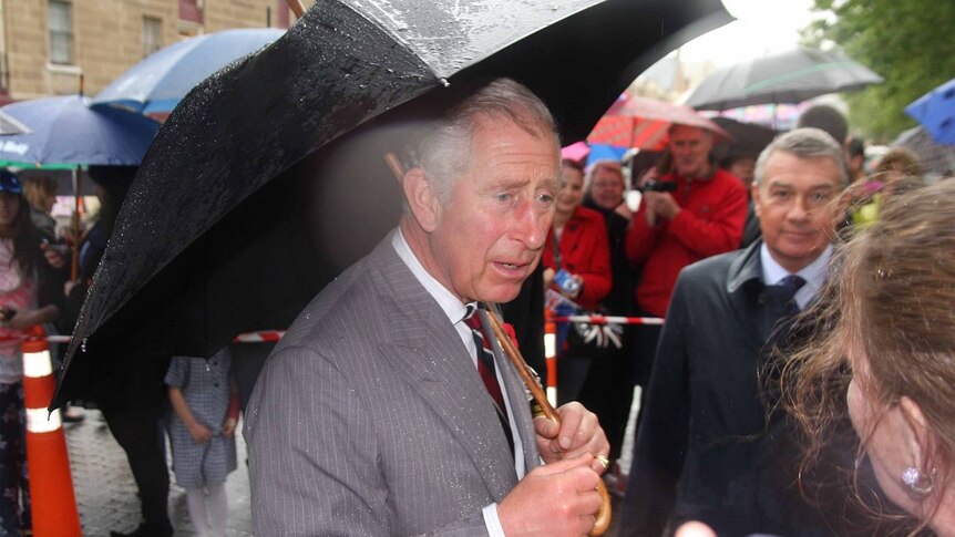 The Prince of Wales talks to the crowd in the rain at Salamanca Place during the royal tour, Nov 8 2012.