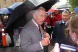 The Prince of Wales talks to the crowd in the rain at Salamanca Place during the royal tour, Nov 8 2012.