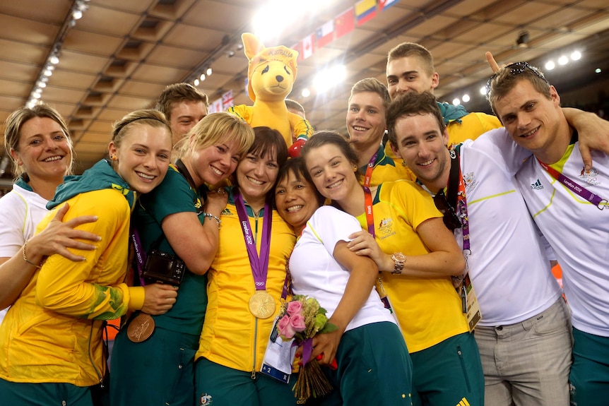 Anna Meares (C) is surrounded by other Australian team members after receiving her gold medal.