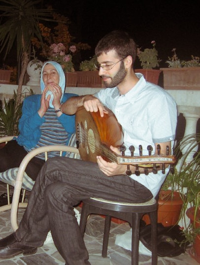Amina (centre) and her son Majd (right) playing the lute.