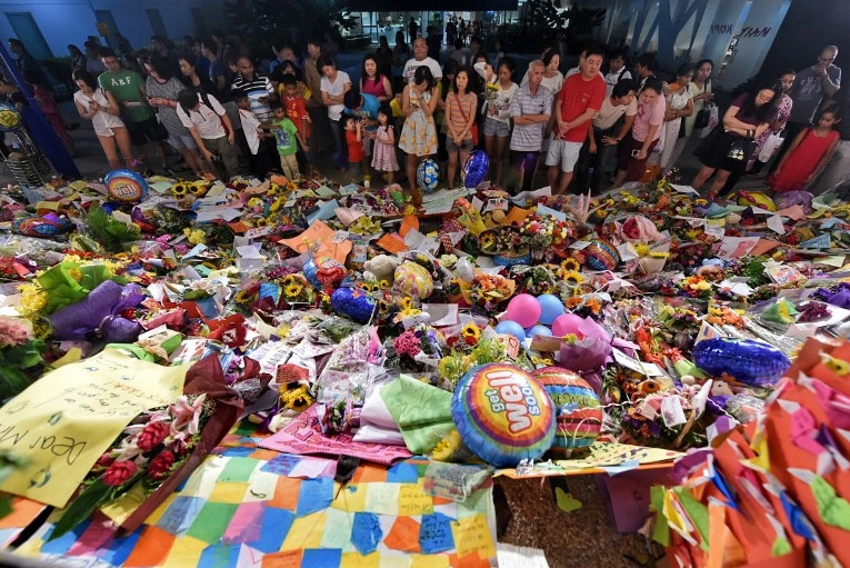 People pay tribute outside the Singapore General Hospital where elder statesman Lee Kuan Yew remains critically ill in the Intensive Care Unit