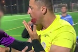 a man with a bleeding mouth on a sports field