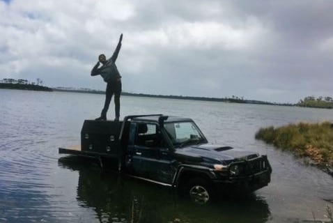 Braidon Fletcher posing on a ute, undated photo.