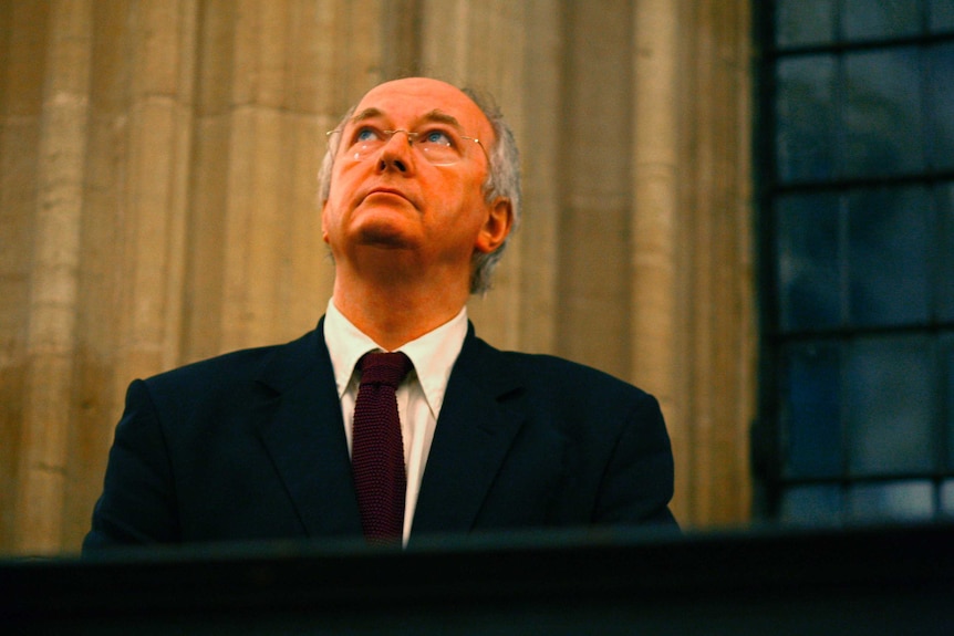 British author Philip Pullman looks up while preparing to give a speech