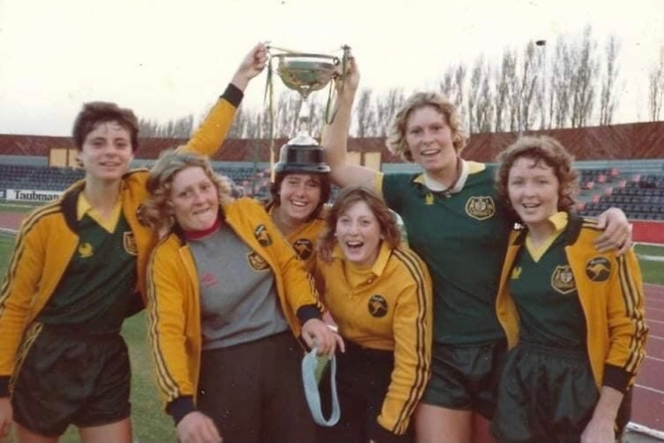 Australian women soccer players hold a trophy after a match