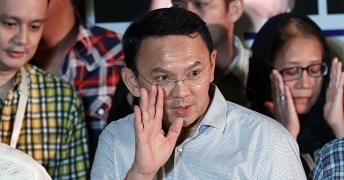 Former Jakarta governor Ahok waves in a crowd of people