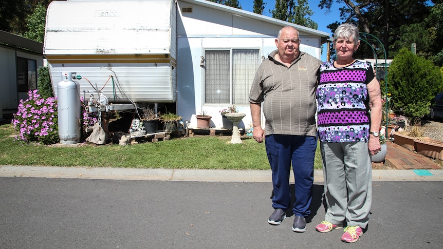 Larry and Lyn Fox standing outside of their caravan at Central City Caravan Park in Bendigo.