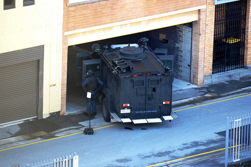 STAR Group officers stand guard during a siege involving fugitive Rodney Ian Clavell.