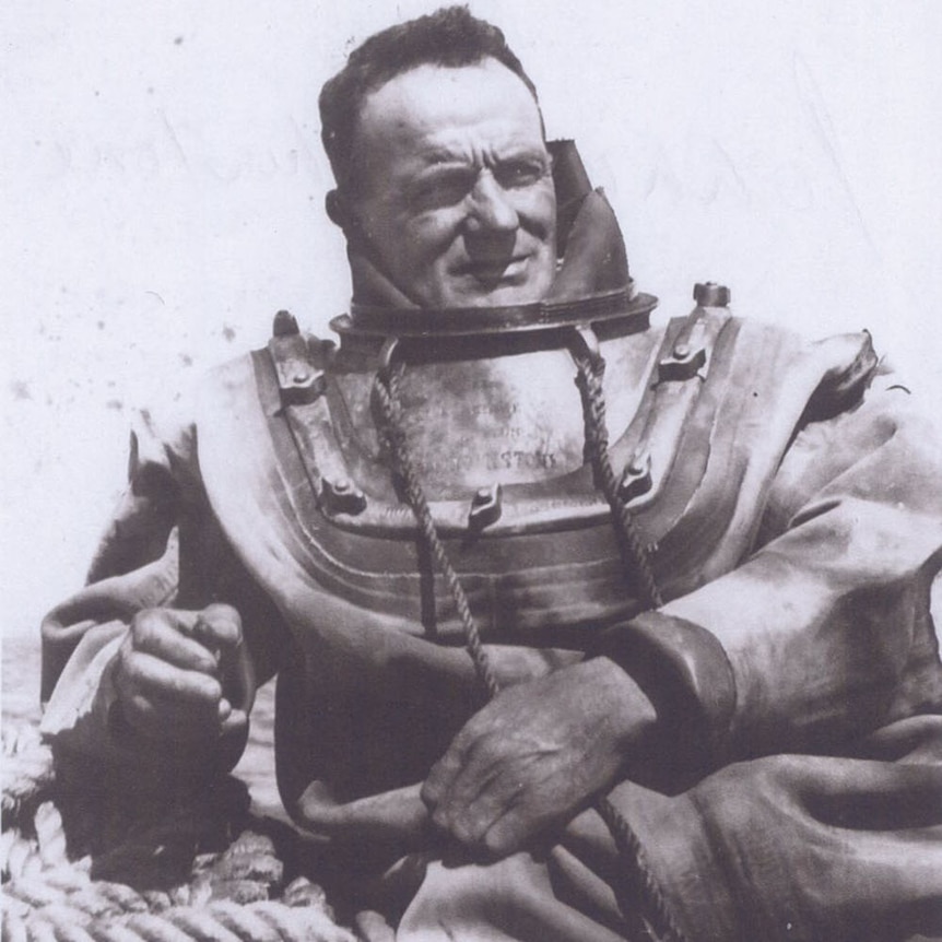Historic monochrome portrait of diver in old fashioned, heavy  deep-sea dive suit