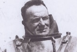 Historic monochrome portrait of diver in old fashioned, heavy  deep-sea dive suit