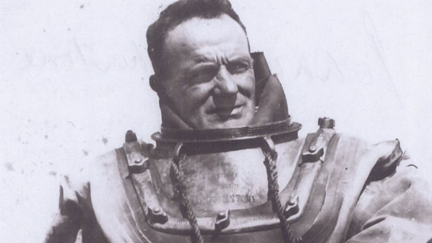 Historic monochrome portrait of diver in old fashioned, heavy  deep-sea dive suit