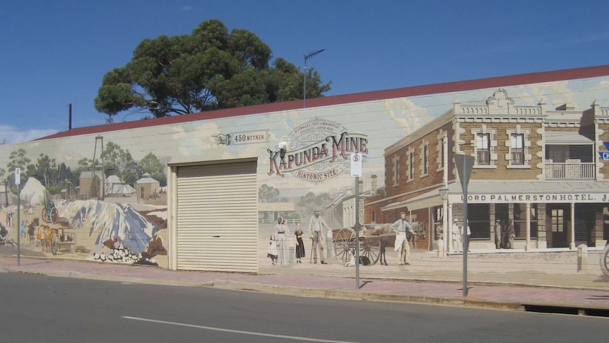 A large mural featuring a mine in a country town.