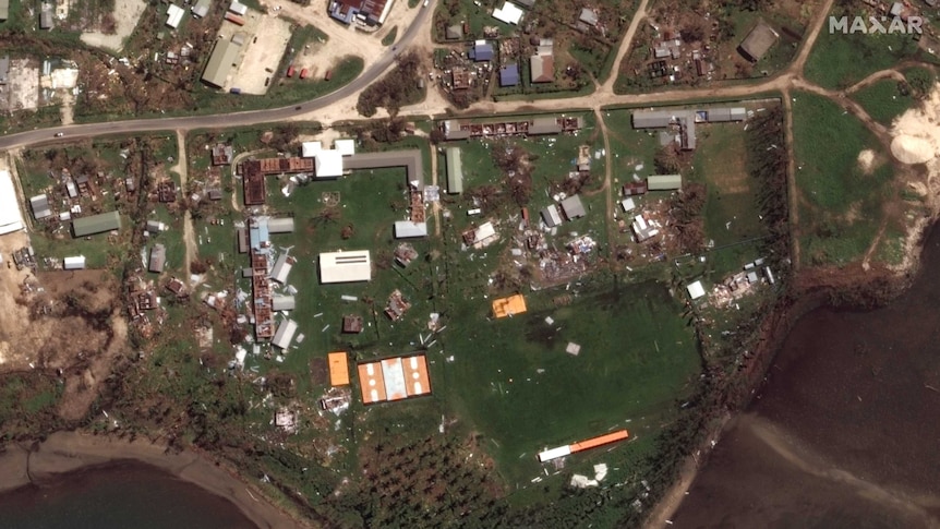 Destroyed houses and can be seen from above surrounded by debris.