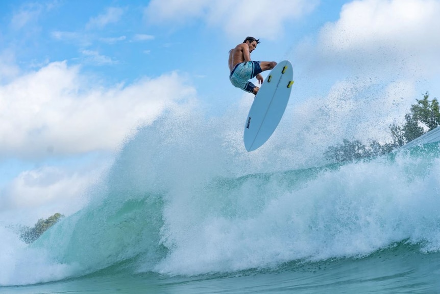 large wave and surfer in the air