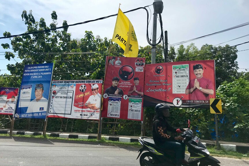 Banners showing political parties and candidates on the side of a road in Bali.