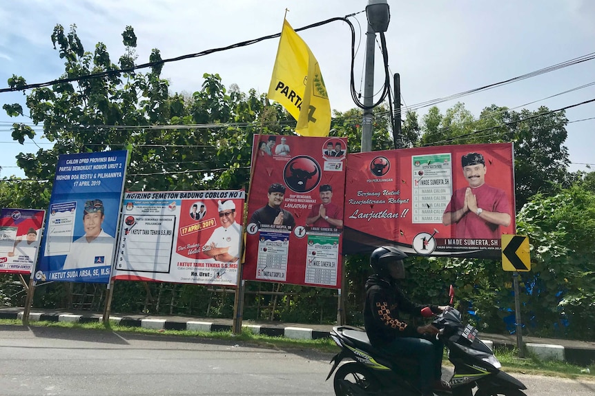 Banners showing political parties and candidates on the side of a road in Bali.