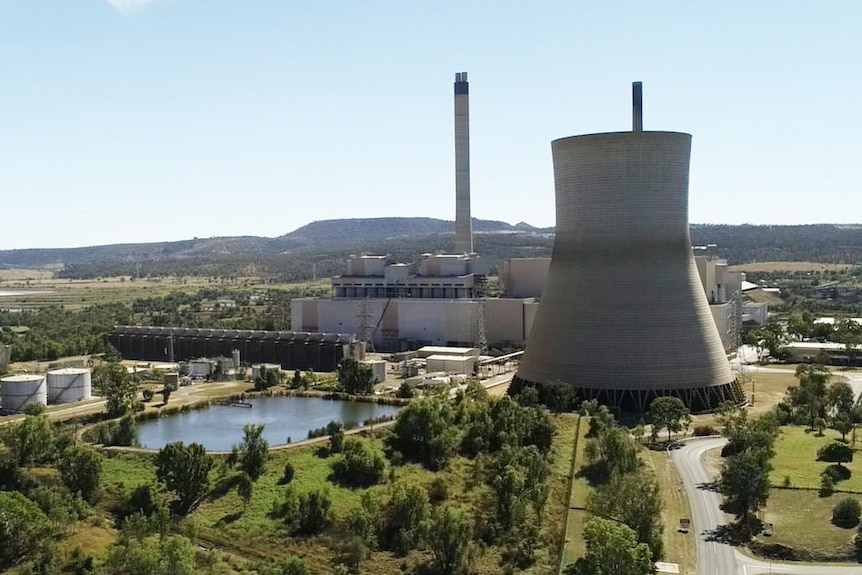 A cooling tower at a power station in the countryside.