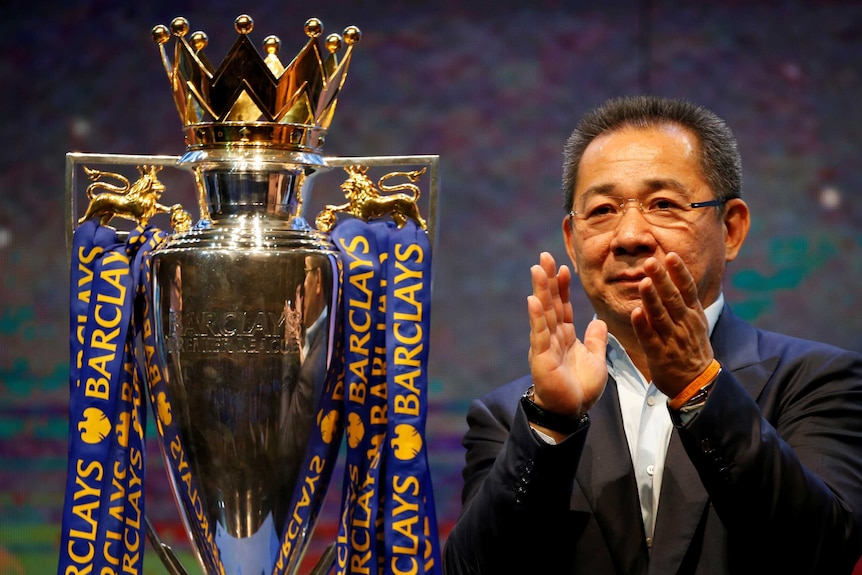 Leicester City owner Vichai Srivaddhanaprabha alongside Premier League trophy