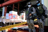 Anti-narcotic officers guard confiscated drugs in Philippines.