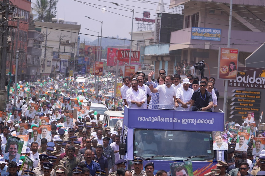 Rahul Gandhi and his sister atop a truck in Kalpetta, Wayanad, driving slowly through an enormous crowd of supporters.