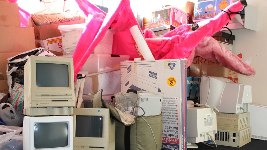 A collection of memorabilia stacked in an office.