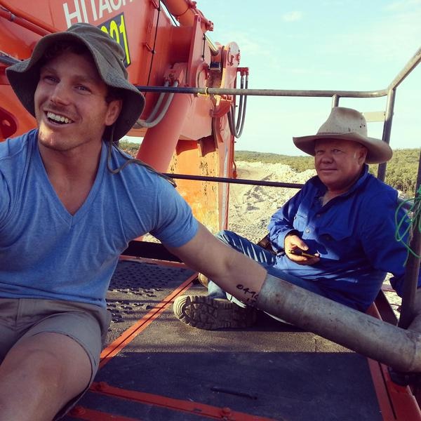 David Pocock (L) and farmer Rick Laird (R) sit on mining equipment
