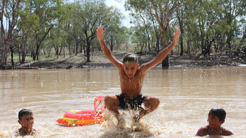 Three children play in the Namoi River at Walgett.