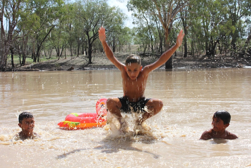 Three children play in the Namoi River at Walgett.