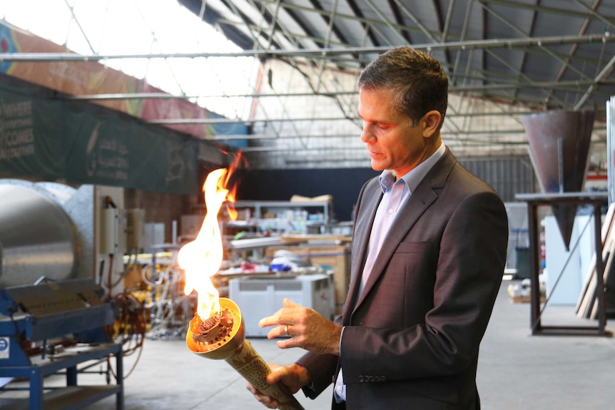 FCT Flames CEO David Retallack holds the Baku torch