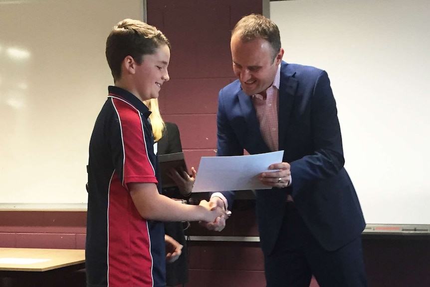 Ross Kelly receiving his award from Andrew Barr.